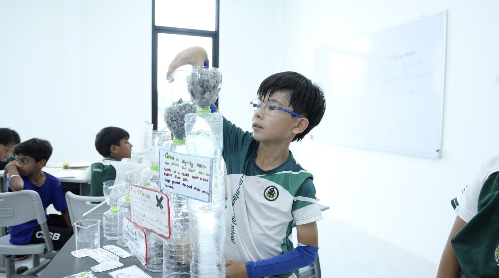 Primary School student building a water filtration model at CISB - 1